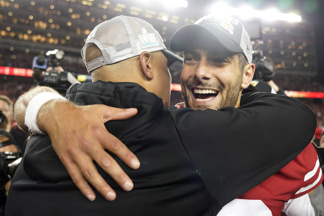 San Francisco 49ers quarterback Jimmy Garoppolo, right, celebrates with assistant coach Miles A ...