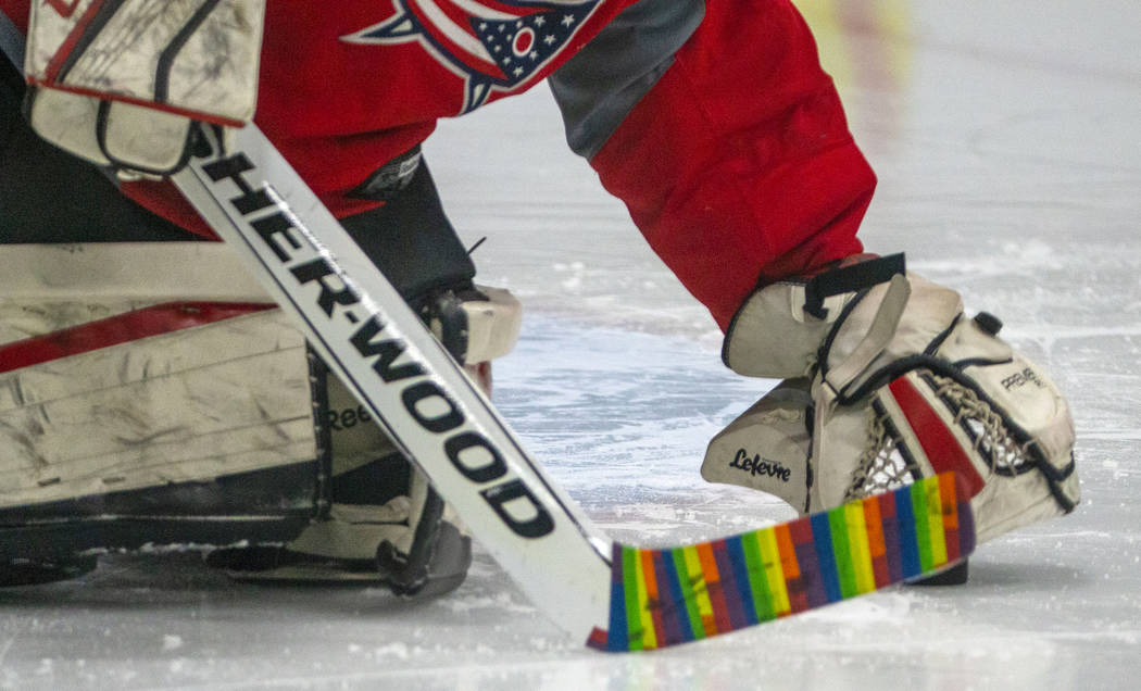 Flamingos goalie makes a stop sporting a rainbow-wrapped stick against the Blackjacks during th ...