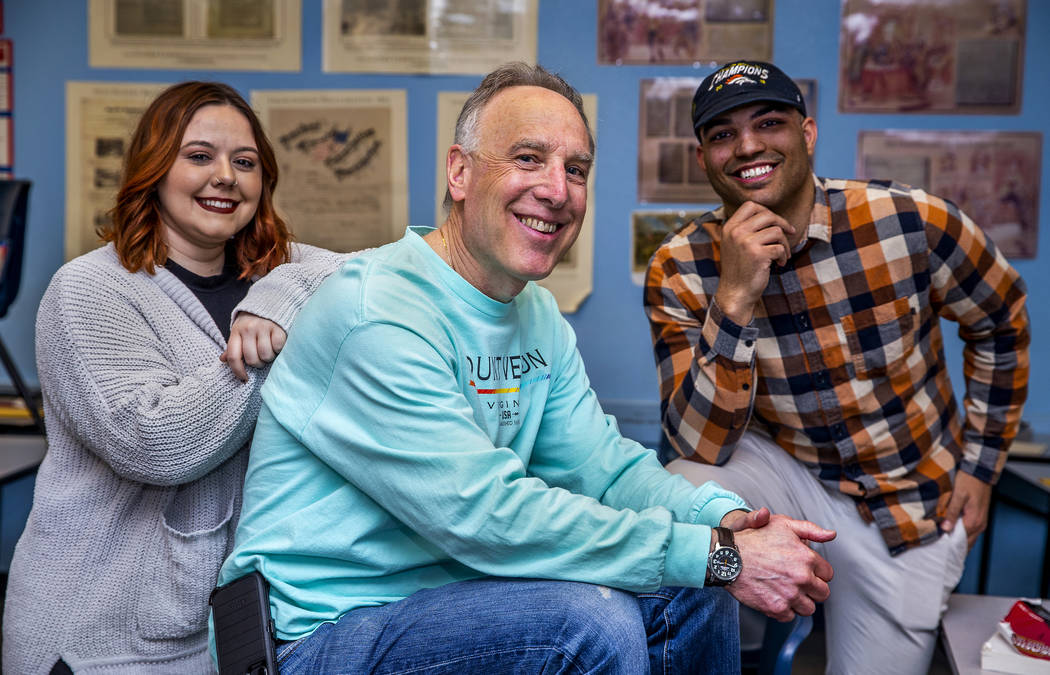 Leavitt Middle School Holocaust teacher Mitchell Kalin, center, with former students Tiara Simp ...