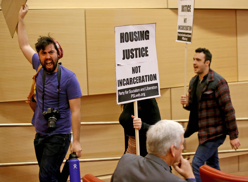 Merrick Haji-Sheikh, from left, Annelise Friedman and Daniel Weber, all of Las Vegas, chant as ...