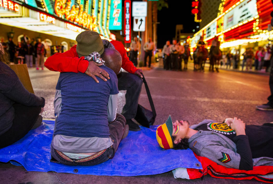 The Rev. Harold Washington-Carnes hugs another local activist as she helps blocks Casino Center ...