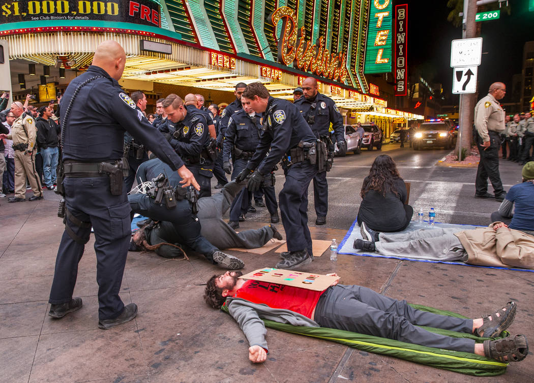 Las Vegas Metropolitan Police officers arrest local activists blocking Casino Center Blvd. thro ...