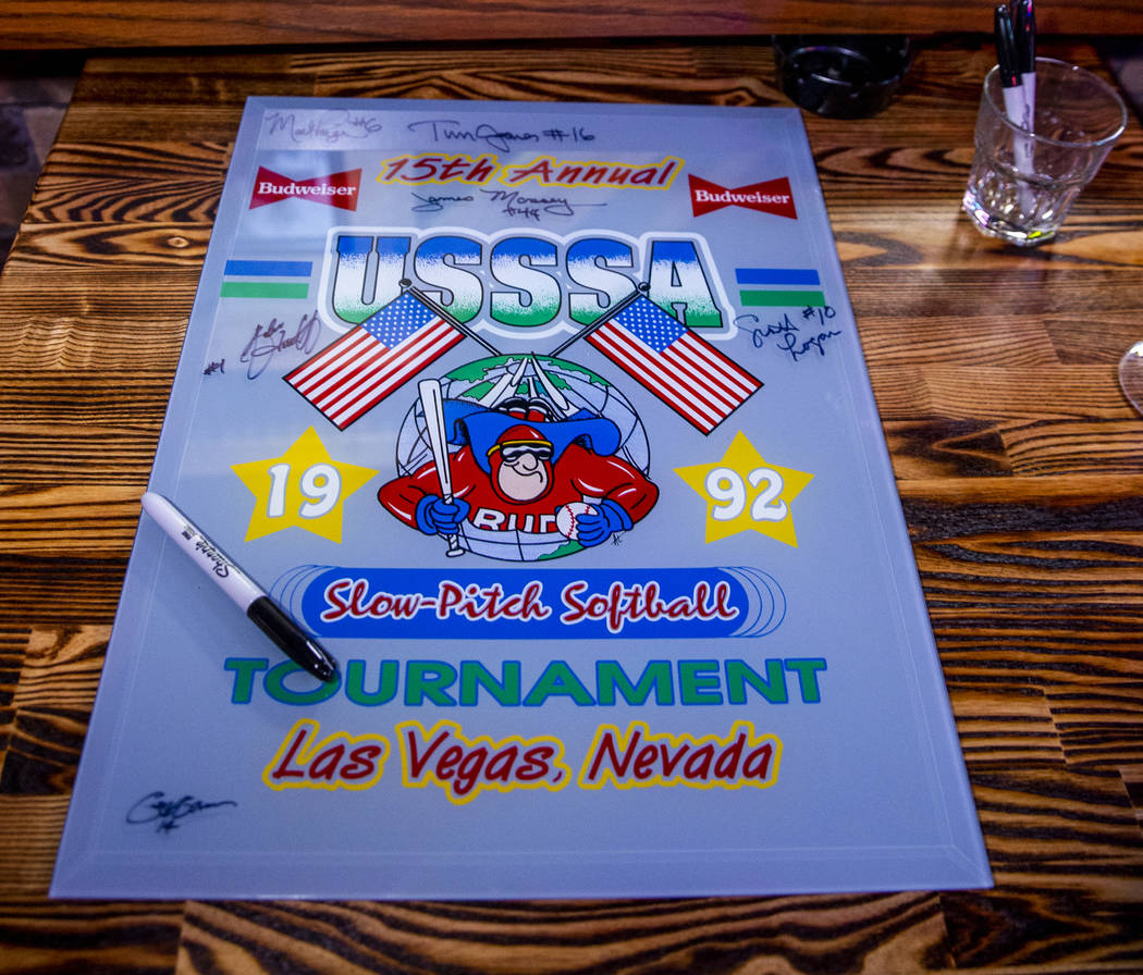 Players are able to sign a piece of memorabilia during the Las Vegas Aces slow-pitch softball t ...