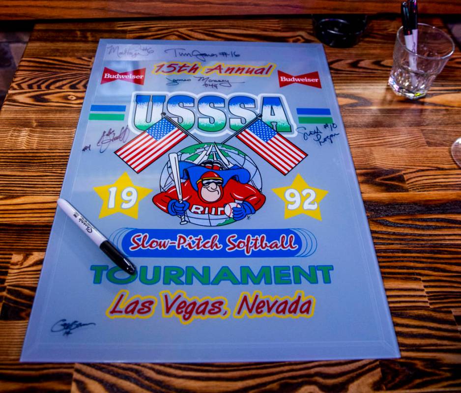 Players are able to sign a piece of memorabilia during the Las Vegas Aces slow-pitch softball t ...
