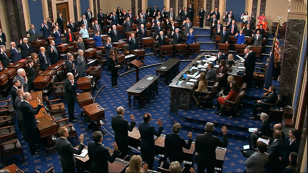 Presiding officer Supreme Court Chief Justice John Roberts swears in members of the Senate for ...