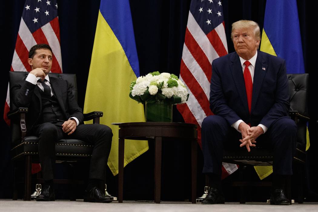 President Donald Trump meets with Ukrainian President Volodymyr Zelenskiy, left, at the InterCo ...