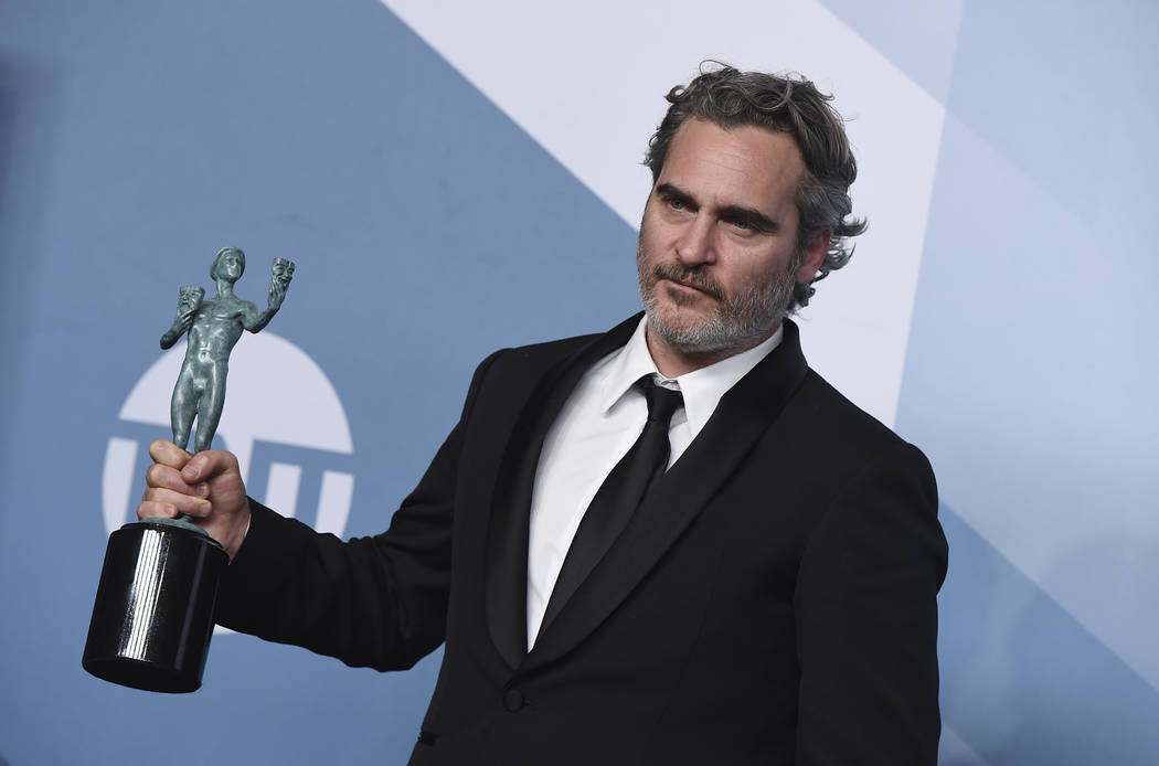 Joaquin Phoenix poses in the press room with the award for outstanding performance by a male ac ...