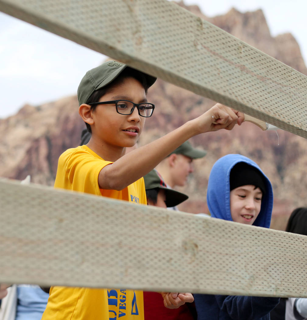 Juan Diego Lara- Hernandez, 12, with Scouts BSA of Las Vegas Troop 219, paints a fence at Sprin ...