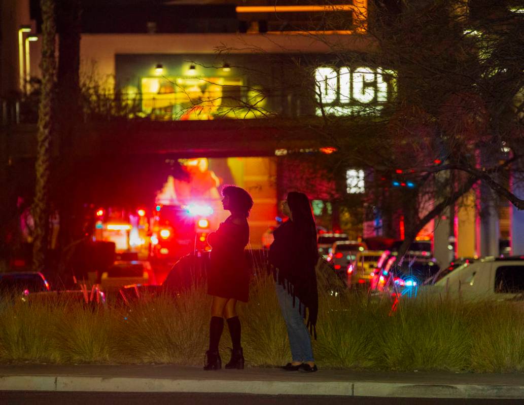 Onlookers watch as the Metropolitan Police Department officers set up with weapons to clear the ...