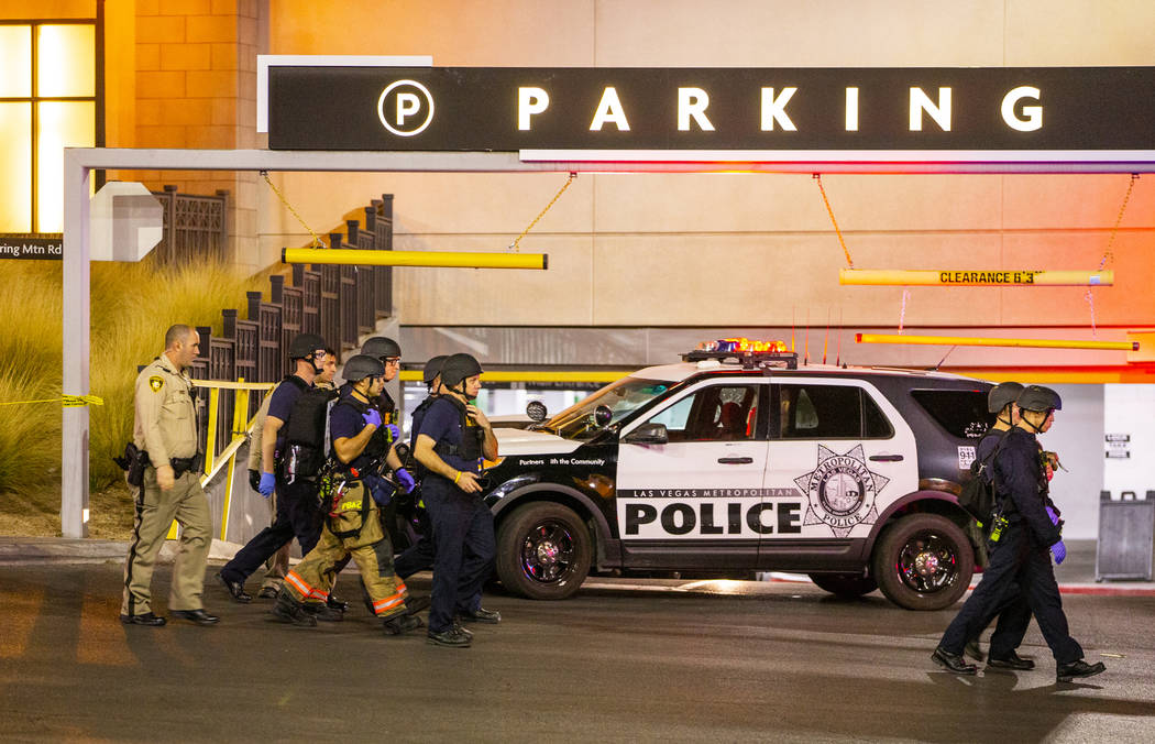 Metropolitan Police Department officers move to a Fashion Show Mall entrance near Macy's for a ...