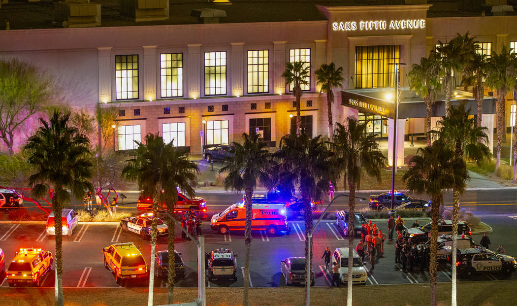 Metropolitan Police Department officers stage at a Fashion Show Mall entrance outside Sak's Fif ...