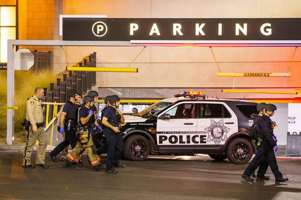 Metropolitan Police Department officers move to a Fashion Show Mall entrance near Macy's for a ...