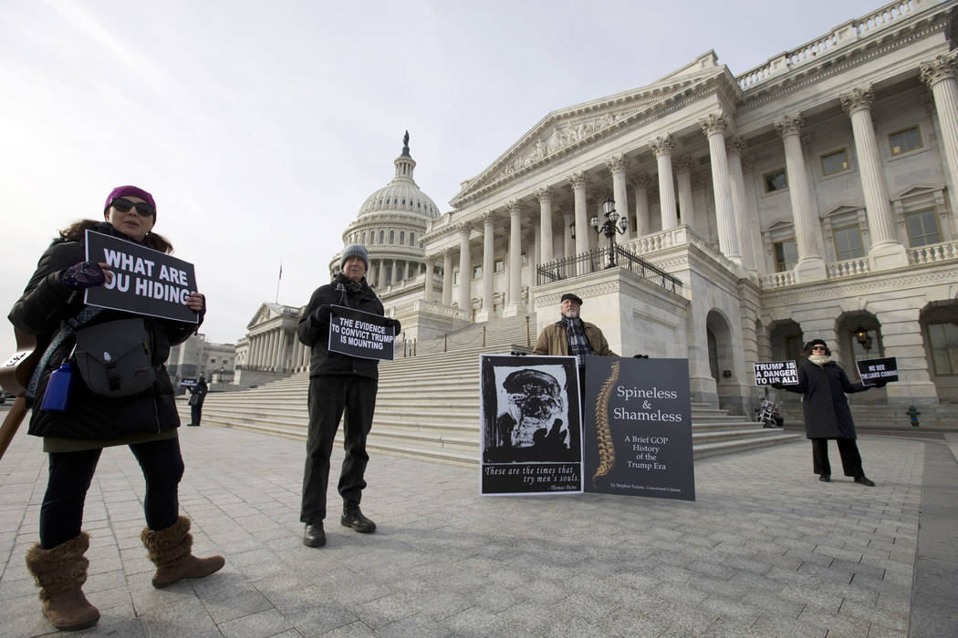 Demonstrators protest outside of the U.S. Capitol during the impeachment trial of President Don ...