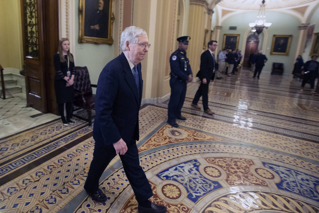 Senate Majority Leader Mitch McConnell, R-Ky., leaves the Senate chamber after the impeachment ...