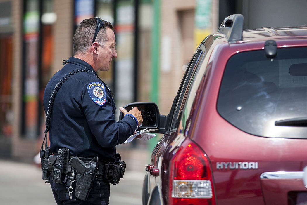 Officer Anthony Gaspardi of the Clark County School District Police gives a motorist a ticket o ...