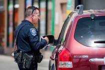 Officer Anthony Gaspardi of the Clark County School District Police gives a motorist a ticket o ...