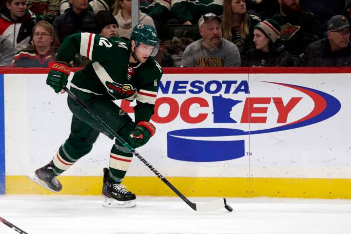 Minnesota Wild center Eric Staal controls the puck against the Calgary Flames during an NHL hoc ...