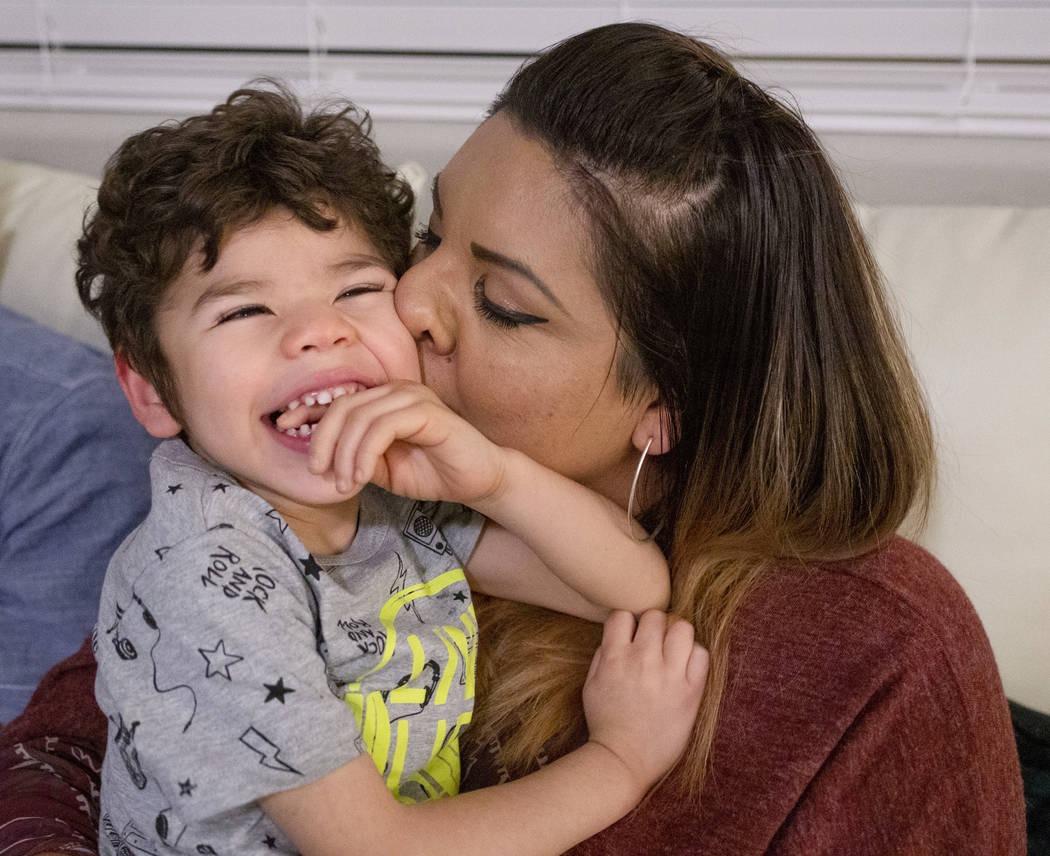 Rio Hansen, 3, is kissed by his mom Cecilia in their home in Henderson on Wednesday, Dec. 18, 2 ...
