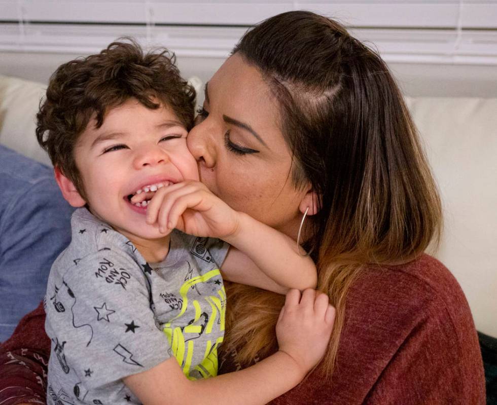 Rio Hansen, 3, is kissed by his mom Cecilia in their home in Henderson on Wednesday, Dec. 18, 2 ...