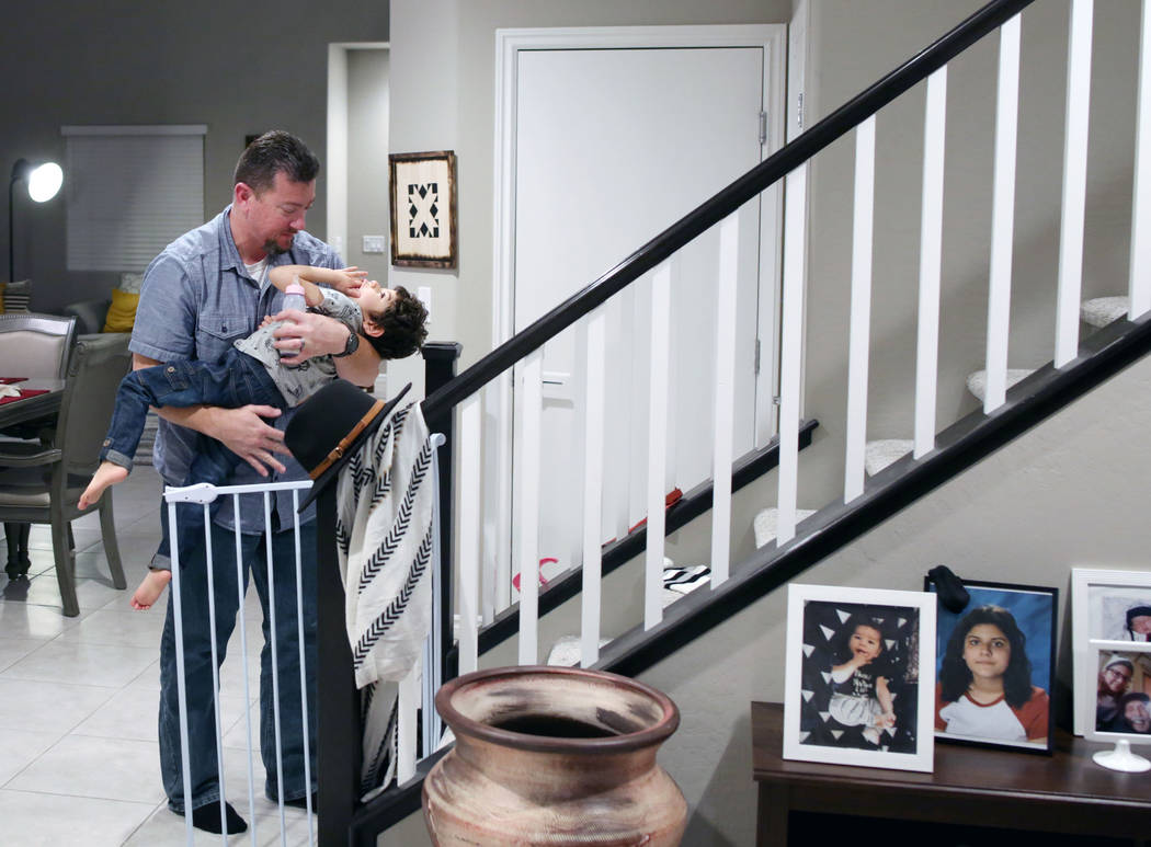 Mike Hansen brings his son Rio, 3, up to bed in their home in Henderson on Wednesday, Dec. 18, ...