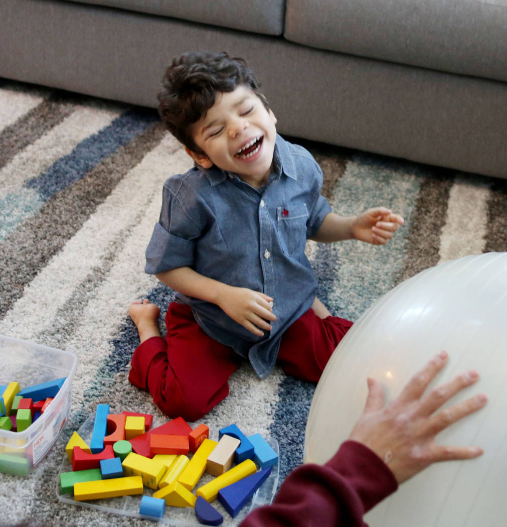 Rio Hansen, 3, works on an exercise during occupational therapy at his home in Henderson on Fr ...