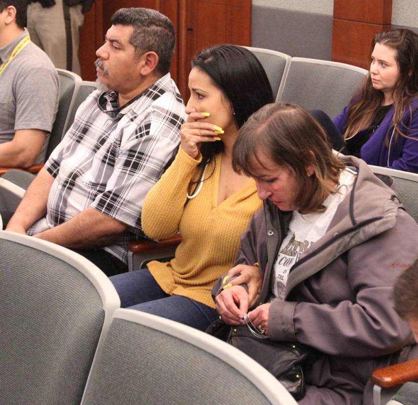 Alice Garcia, sister of Kelly Deanne Kazoon, right, clutches a silver cross that contained her ...