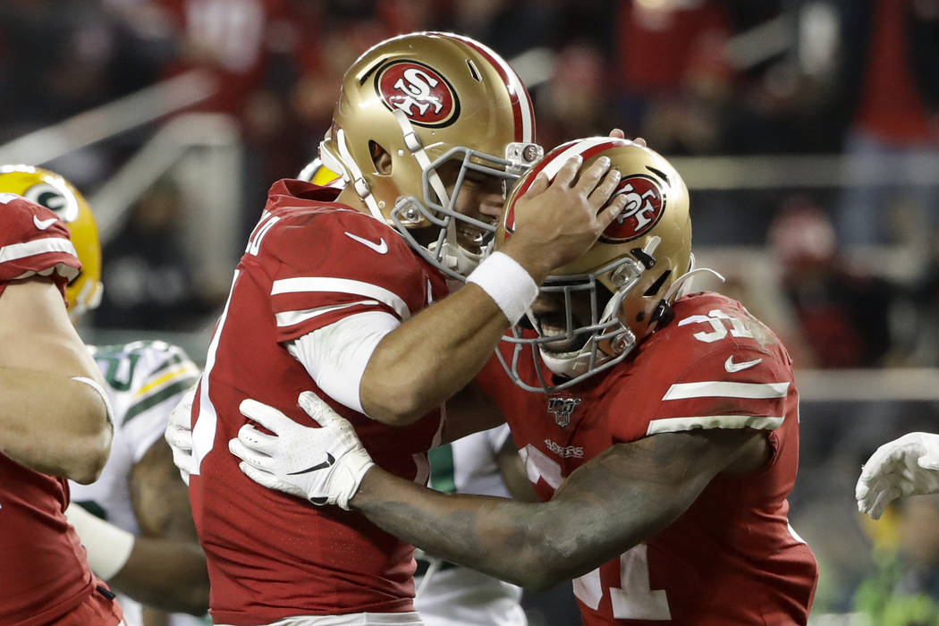 San Francisco 49ers running back Raheem Mostert, right, celebrates his touchdown with quarterba ...