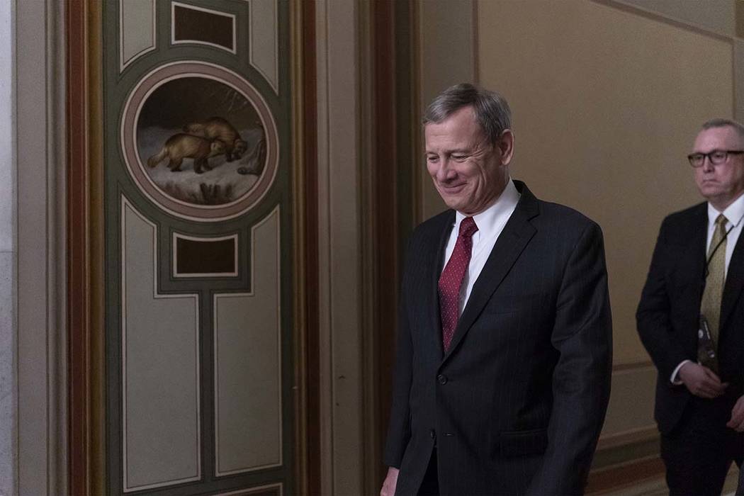 Chief Justice of the United States John Roberts departs the Capitol as the Senate finishes its ...