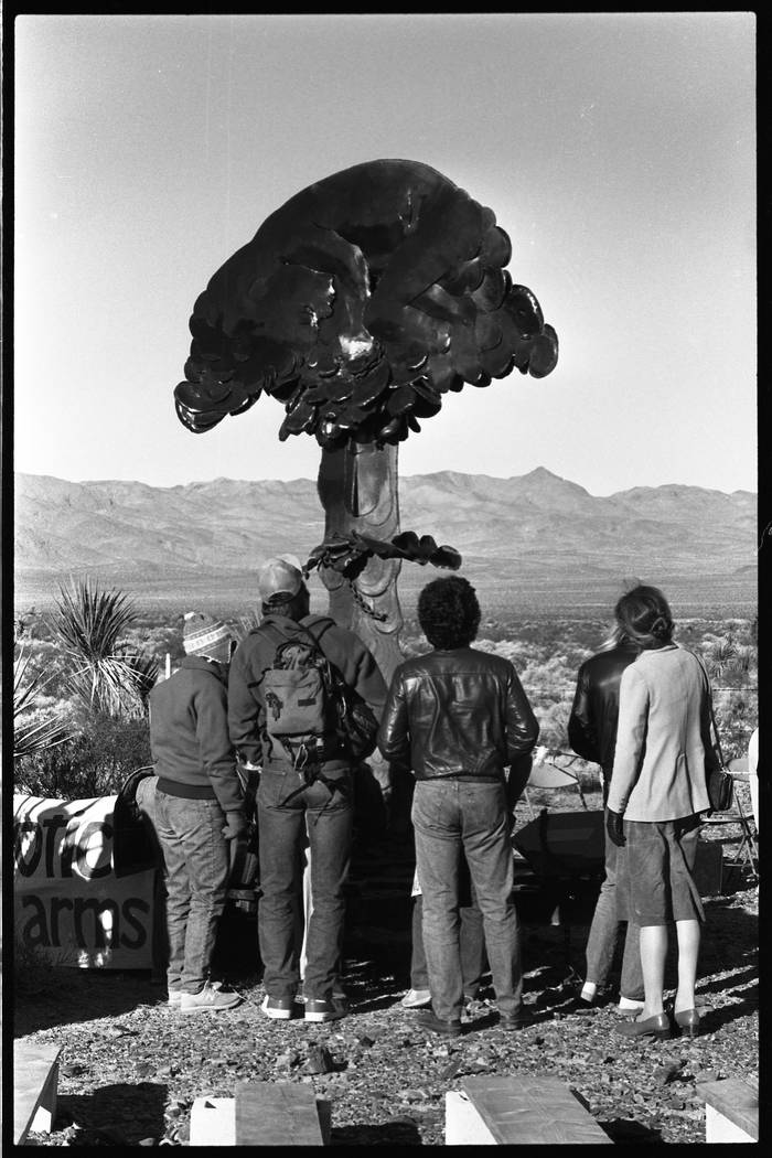 Protesters at a 1987 demonstration examine a sculpture of a mushroom cloud. (Review-Journal fil ...