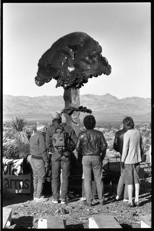 Protesters at a 1987 demonstration examine a sculpture of a mushroom cloud. (Review-Journal fil ...