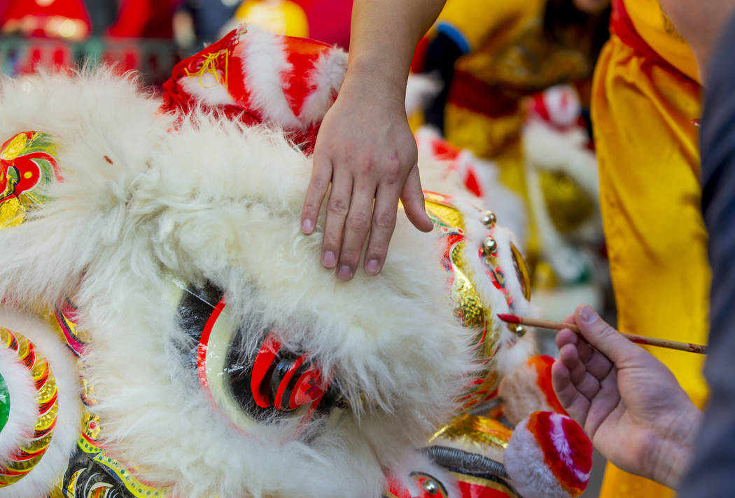 Eyes are painted on the lions as performers with the Yau Kung Moon dance troupe from San Franci ...