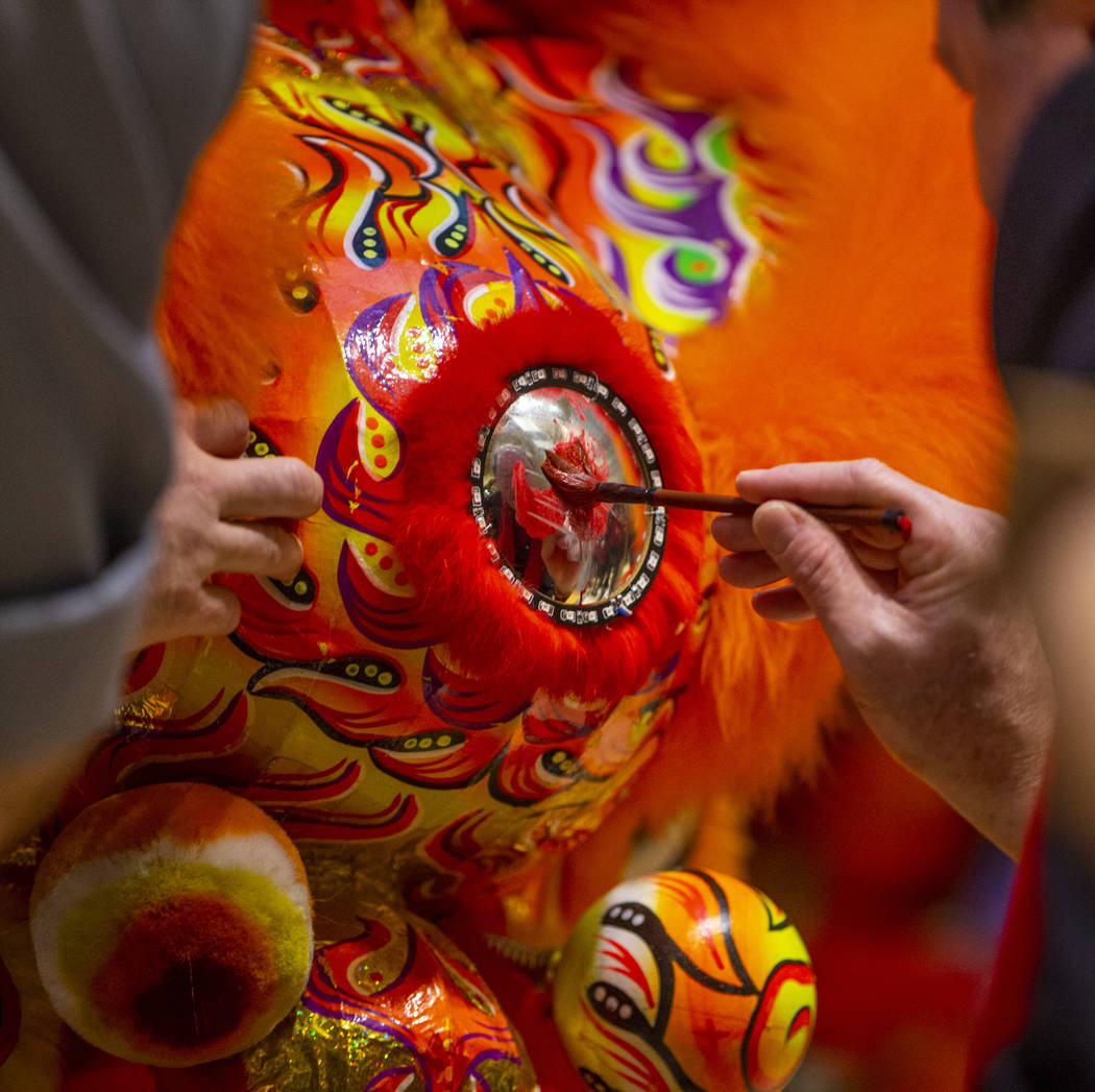 The Lohan School of Shaolin help paint the lions as they ready for a lion dance as the Grand Ca ...