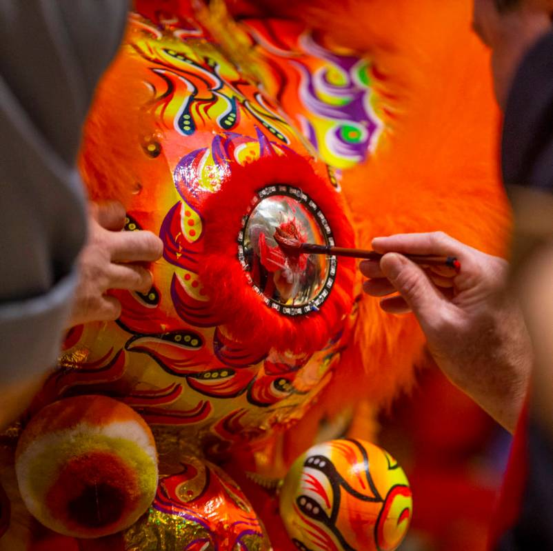The Lohan School of Shaolin help paint the lions as they ready for a lion dance as the Grand Ca ...