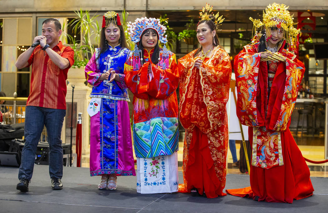 Performer Jee Wong, left, sings a traditional song amongst models in various Chinese dynasty dr ...