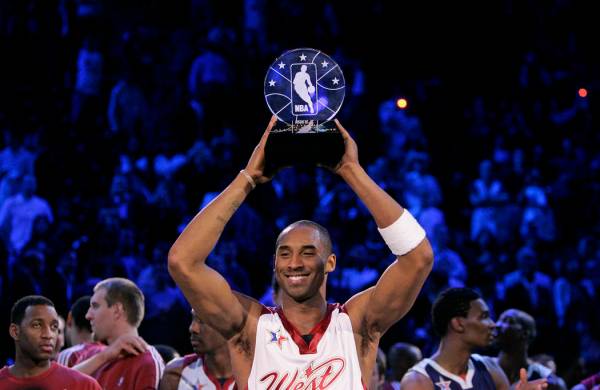 NBA Western Conference player Kobe Bryant holds up the Most Valuable Player trophy after it was ...