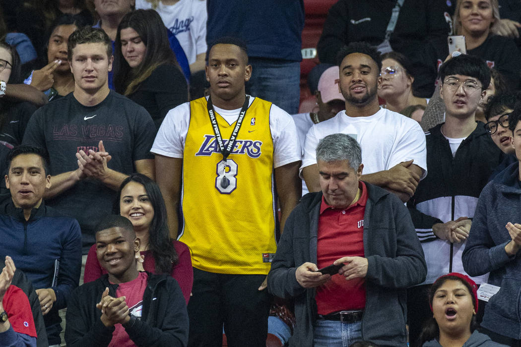 A fan wears a Kobe Bryant Lakers' jersey as he watches the UNLV Rebels battle the San Diego Sta ...
