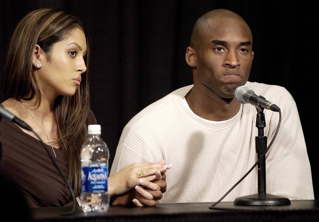 ** FILE ** Los Angeles Lakers' Kobe Bryant holds the hand of his wife Vanessa as he pauses duri ...