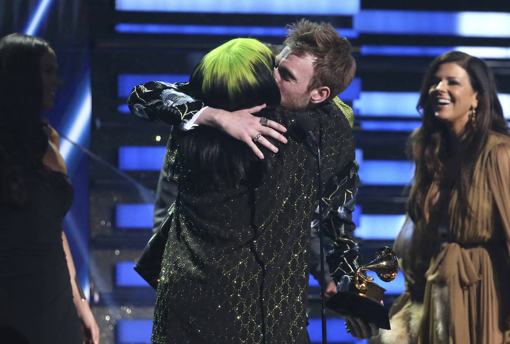 Billie Eilish, left, and Finneas O'Connell embrace after accepting the award for song of the ye ...