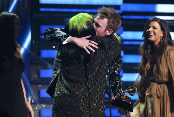 Billie Eilish, left, and Finneas O'Connell embrace after accepting the award for song of the ye ...