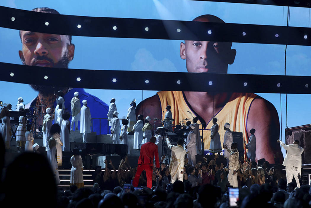 YG, from left, John Legend, Kirk Franklin, DJ Khaled and Meek Mill point to a screen showing Ni ...