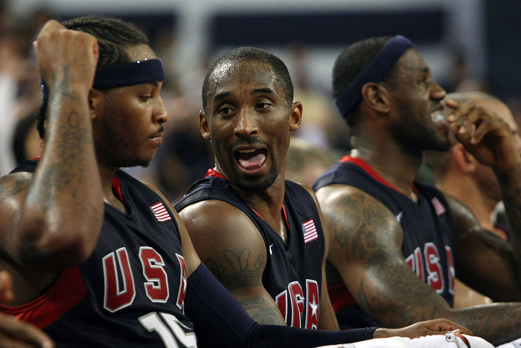 Kobe Bryant, center, and Carmelo Anthony, left, of the USA men's basketball team chat during a ...