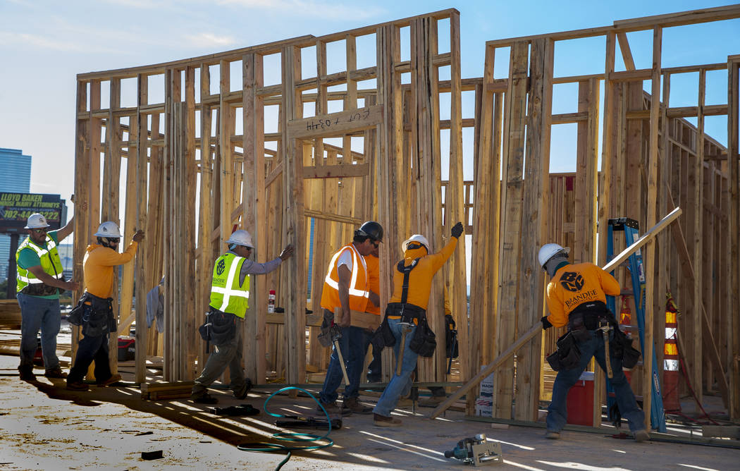 Framers continue on a new apartment complex by developer Jonathan Fore currently under construc ...