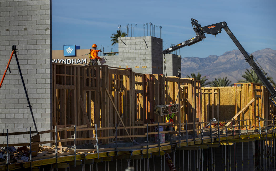 Framers continue on a new apartment complex by developer Jonathan Fore currently under construc ...