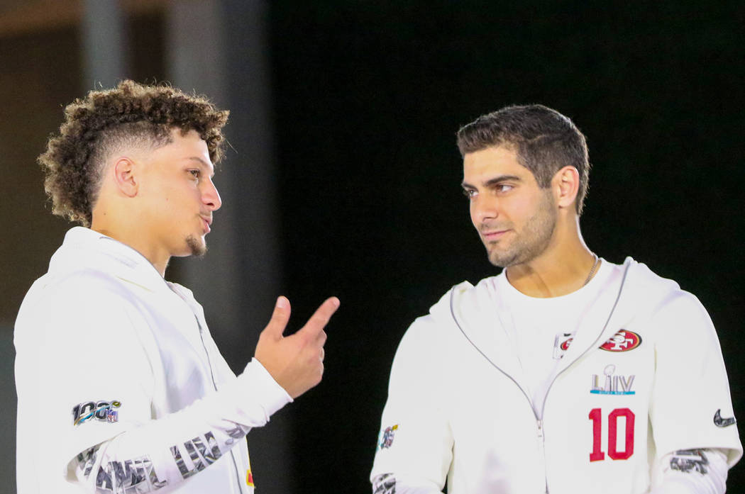 Kansas City Chiefs quarterback Patrick Mahomes, left, speaks to San Francisco 49ers quarterback ...