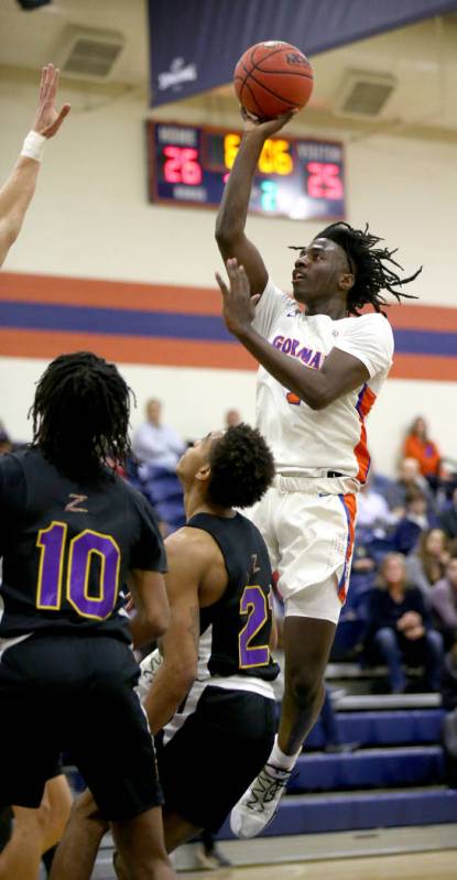 Bishop Gorman guard Will McClendon (1) shoots over Durango guards Keshon Gilbert (10) and Antho ...