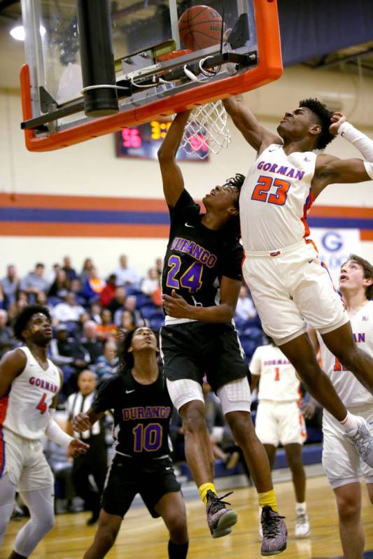 Bishop Gorman forward Mwani Wilkinson (23) blocks a shot by Durango Kendrick Gilbert (24) in th ...