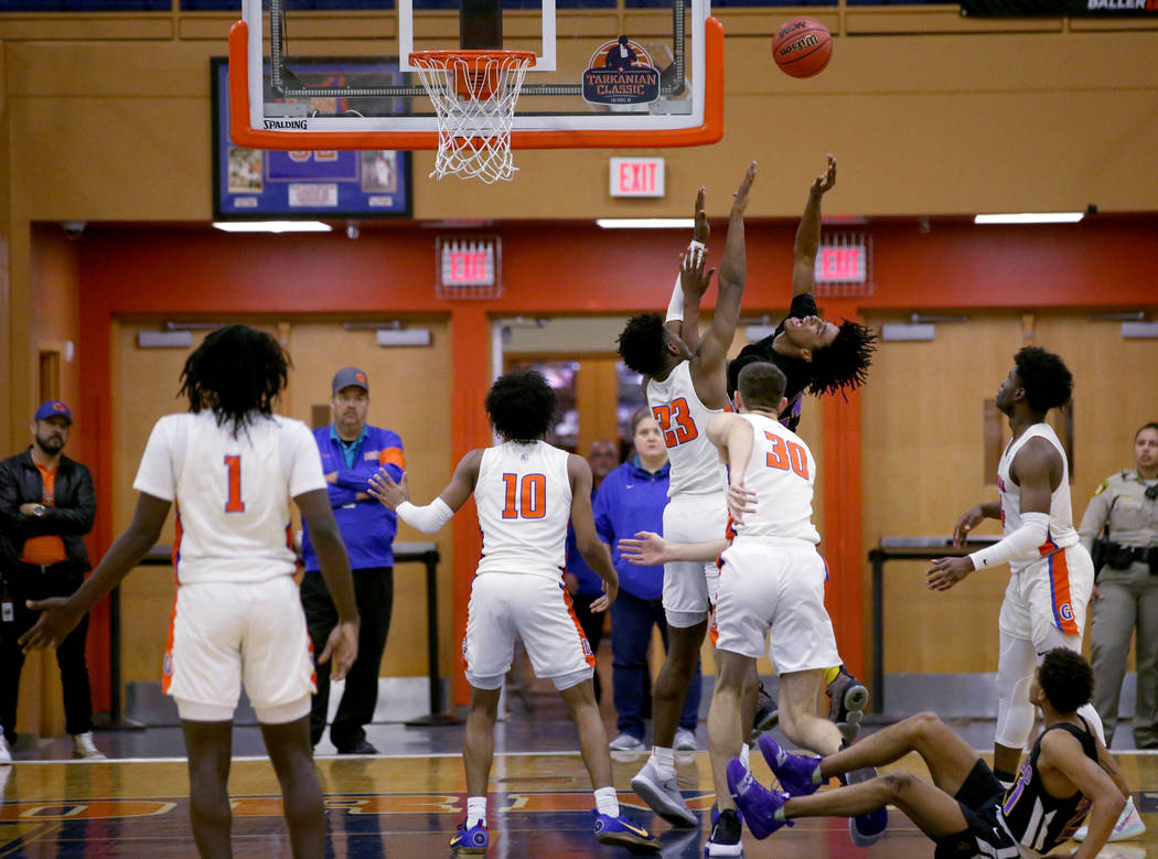 Durango Kendrick Gilbert (24) shoots over Bishop Gorman forward Mwani Wilkinson (23) in the fou ...