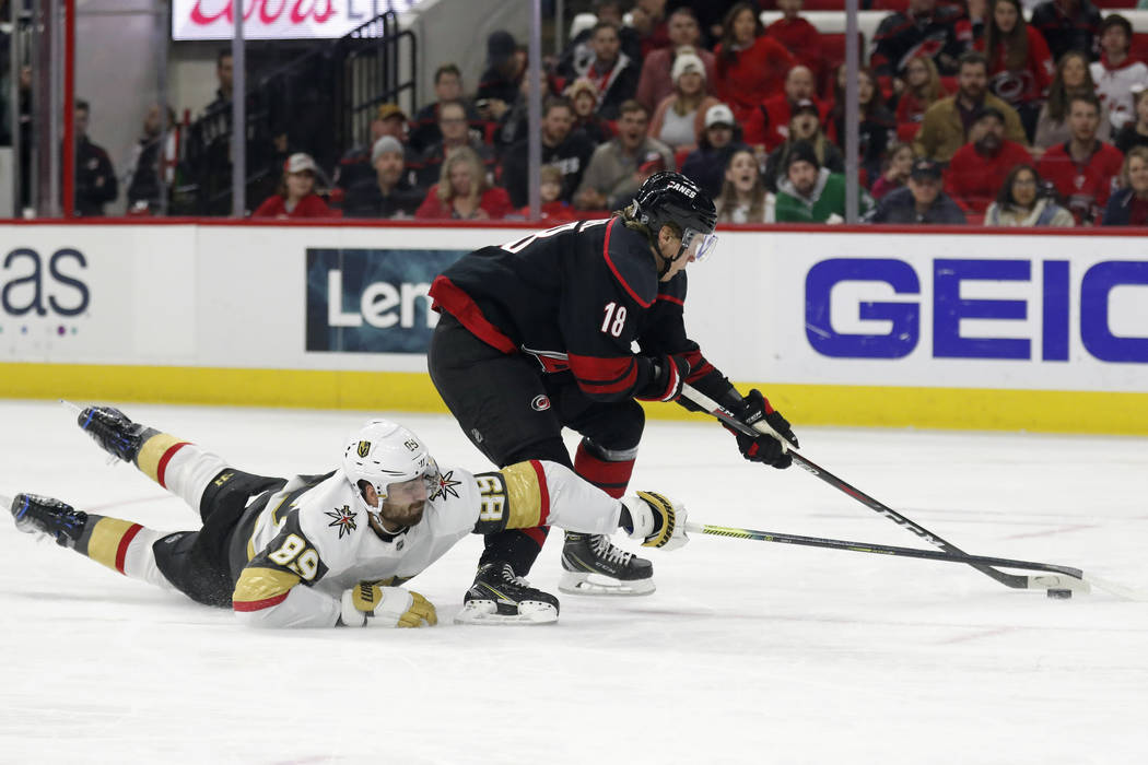 Vegas Golden Knights right wing Alex Tuch (89) dives while chasing the puck with Carolina Hurri ...