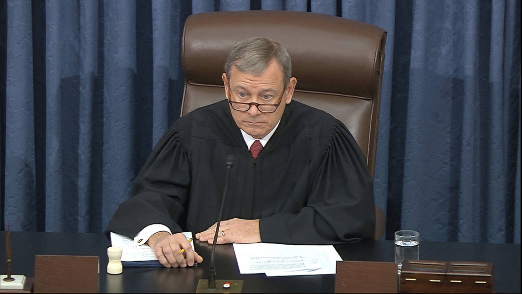 In this image from video, presiding officer Chief Justice of the United States John Roberts lis ...