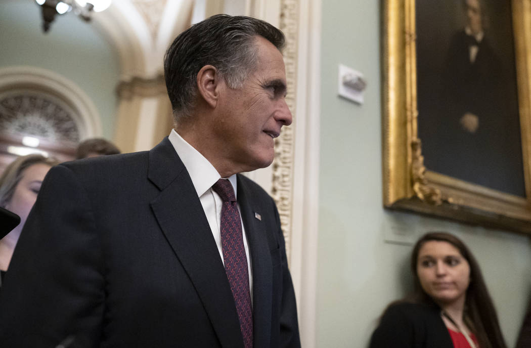 Sen. Mitt Romney, R-Utah, is questioned by reporters during the impeachment trial of President ...